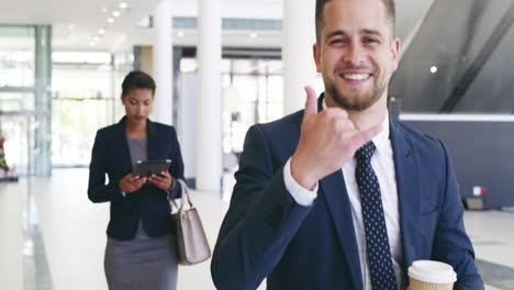 handsome young businessman making a rock out sign