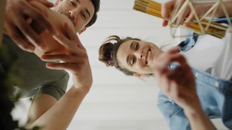 Bottom-view-video-of-couple-putting-things-into-the-cardboard-box.