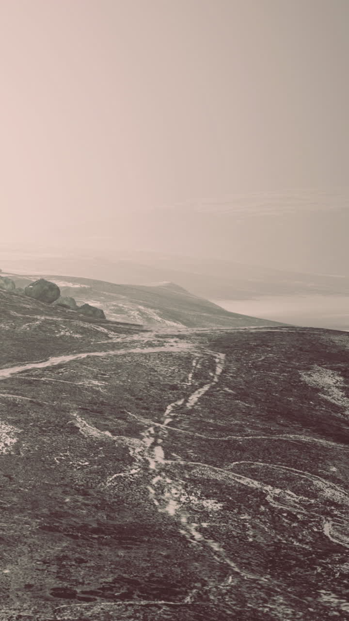 Wide view of a landscape with a path near the coast during low light hours