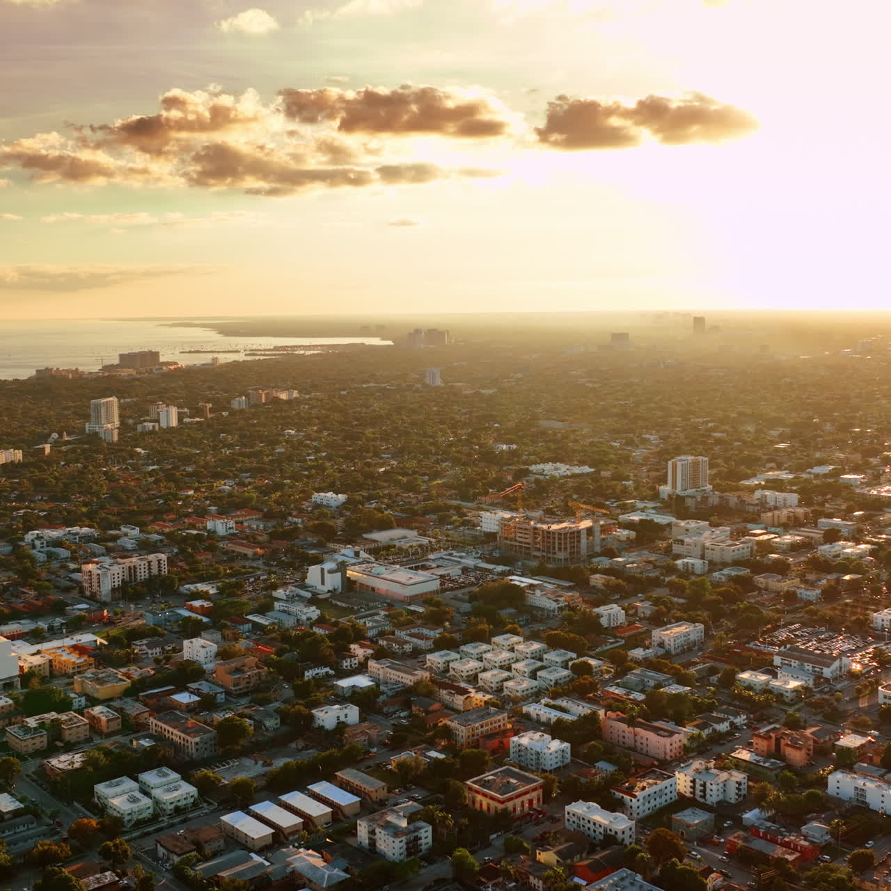 Immense scenery of sunny city on the shore of the Atlantic Ocean. Sunset view of Miami, Florida, USA from top.