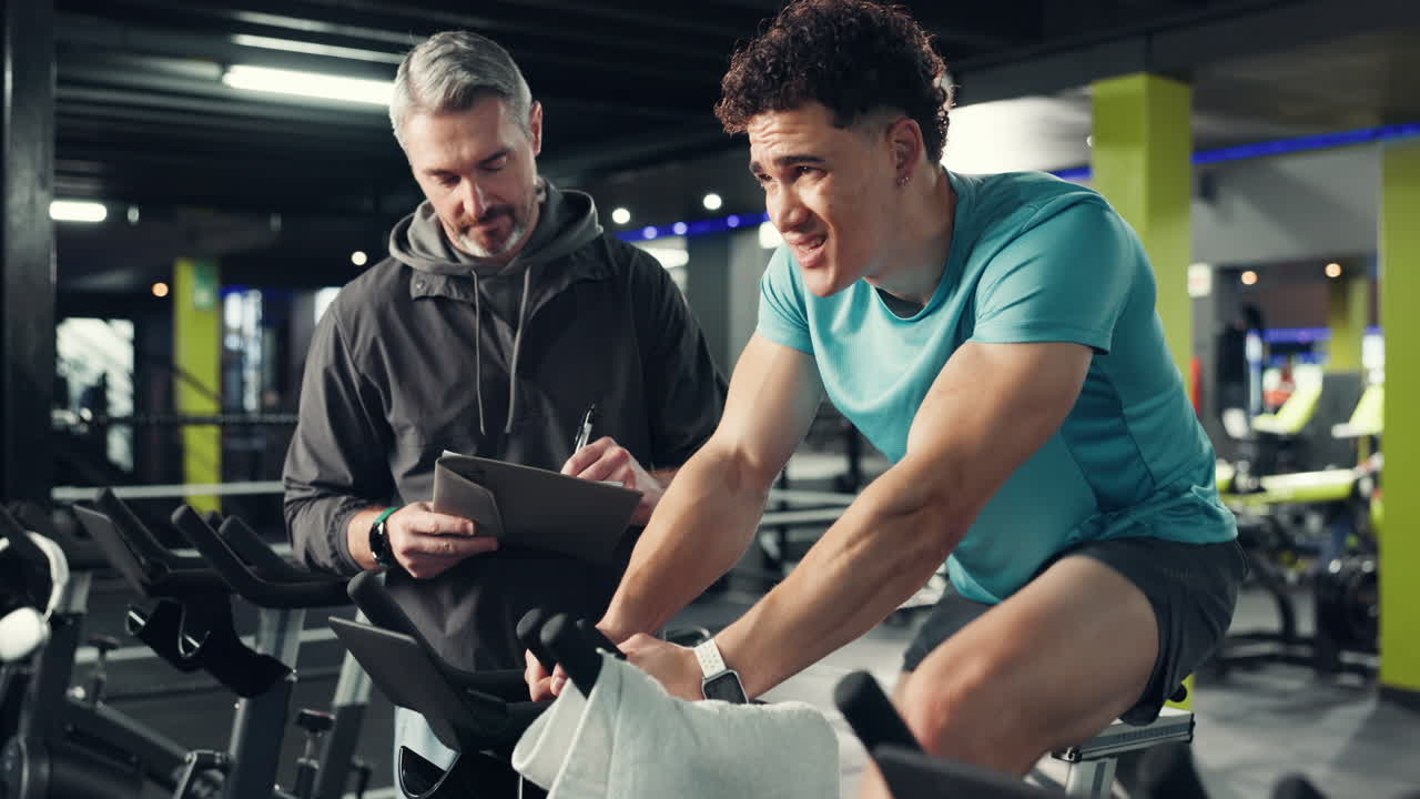 Man Working Out with Trainer at the Gym