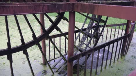 Medium-Shot-of-a-Water-Wheel-Rotating-in-the-River