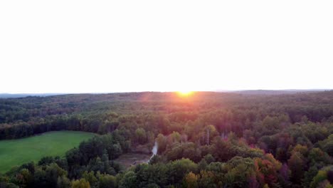 A-long-pan-down-of-a-forest,-and-pond-in-Hallowell-Maine