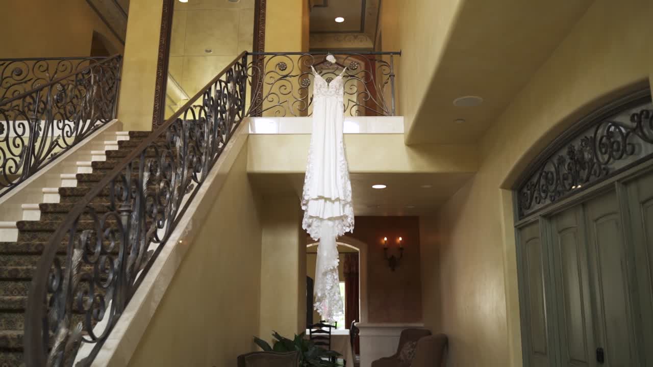 A wedding dress at the top of the stairs in a building
