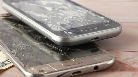 broken smartphones and money