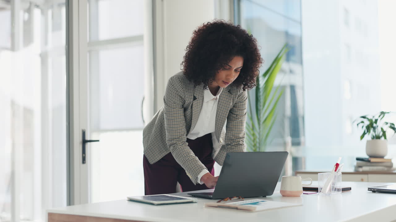 Woman working on laptop in modern office