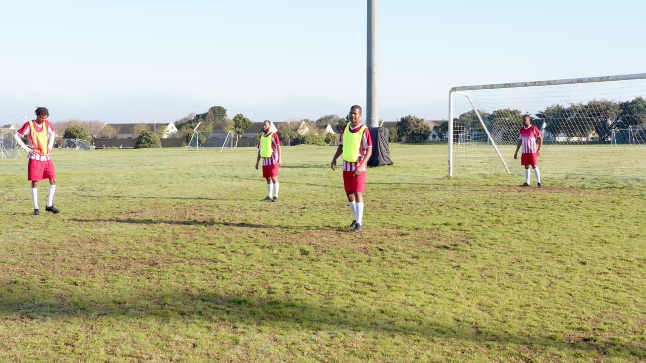 Playing soccer on field, boys in uniforms practicing during training session