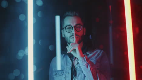 man with glasses in neon light