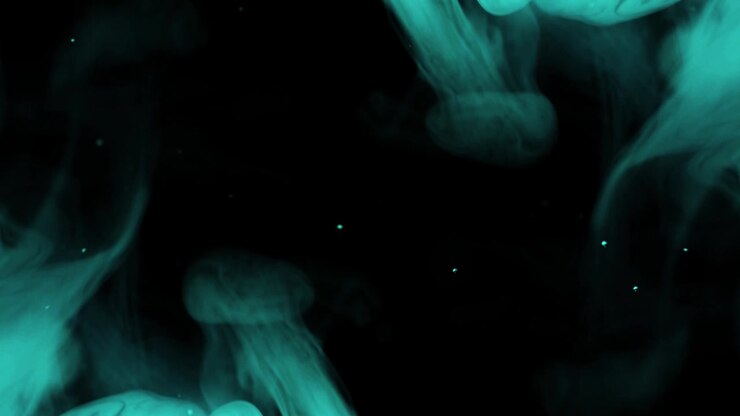 Elegant Wisps of Blue Smoke and Particles Against Black Background