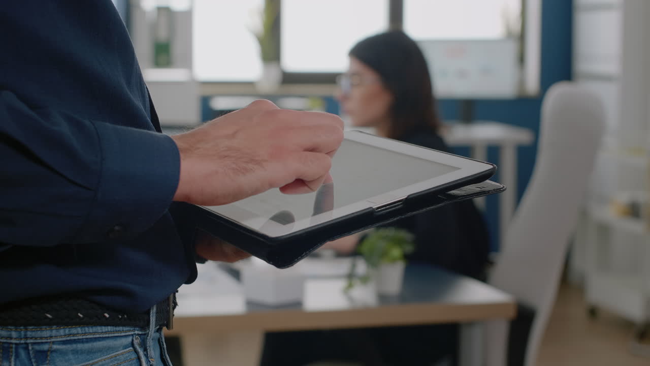 Close up of man using digital tablet for business project