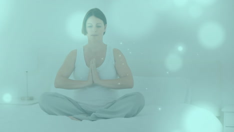 animated pregnant woman meditates with glowing lights on green background for calmness.