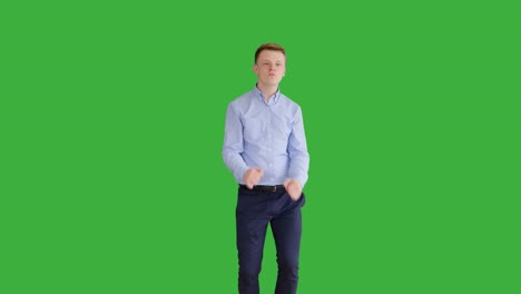 young handsome men acting in front of a green screen. blond hair, blue shirt and blue trousers. dancing, thinking, turning around and talking to the camera.