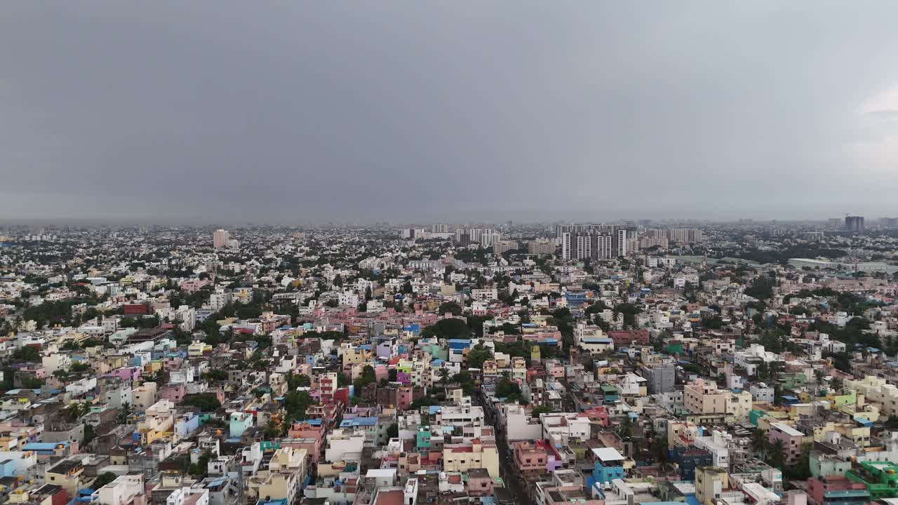 Aerial drizzling weather captured a vast urban sprawl in late afternoon, perfect for showcasing cityscapes, population density, and the vibrant energy of urban life