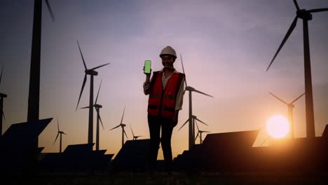 woman engineer in front of wind turbines and solar panels