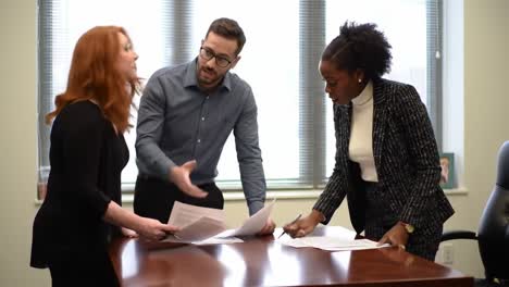 a collaborative meeting: engaged professionals discussing important documents in a modern office setting, fostering ideas and solutions together