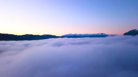 flying through winter clouds at beautiful lake hawea in new zealand