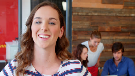 Portrait-of-business-executive-smiling-in-office