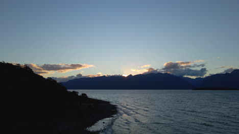 waves crashing ashore of beautiful blue lake te anau in new zealand