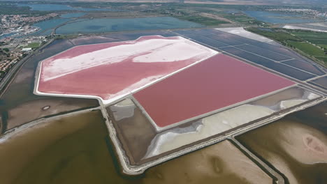 Salt-evaporation-in-large-ponds-South-of-France,-aerial-view-water-rose.