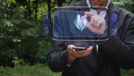 businessman uses hologram with plant