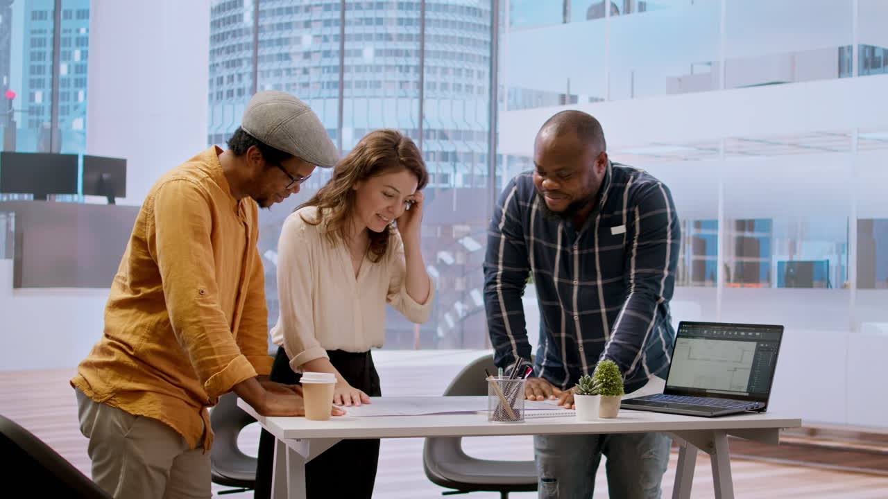 Professional clients and their real estate agent evaluating blueprints