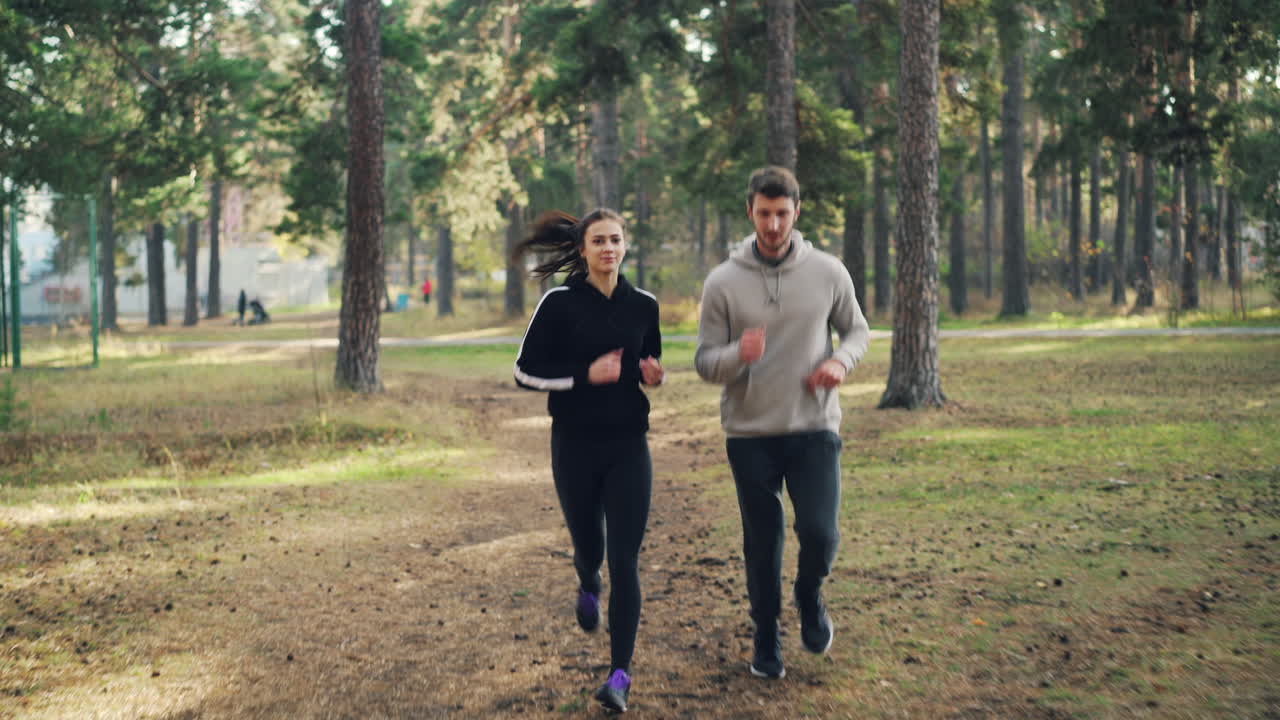 Couple Running in a Forest Park