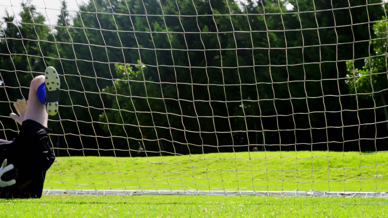 Goalkeeper saves a goal in the field