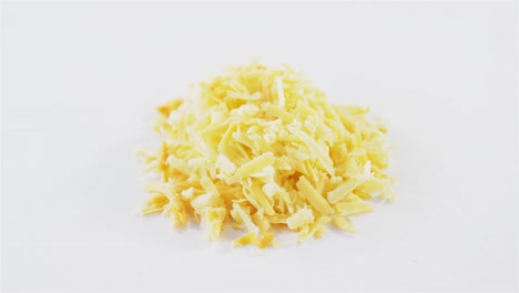 grated cheese on white background