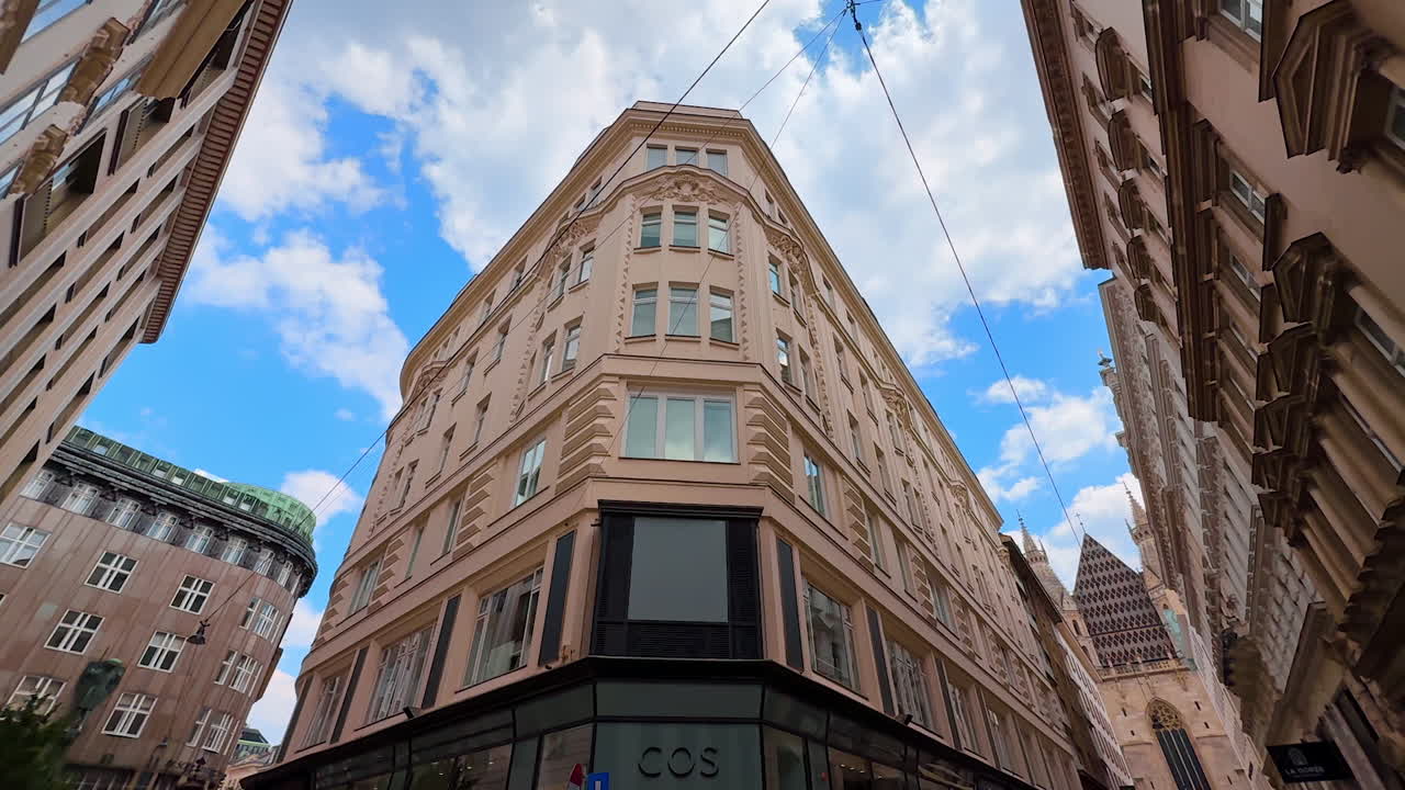 Vienna, Austria - June 9, 2025: Impressive architecture of old town in Vienna, Austria. Long angle view at the stunning windows along the city street