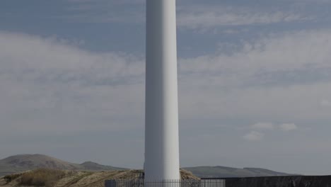 wind turbine in waste ground next to industrial estate