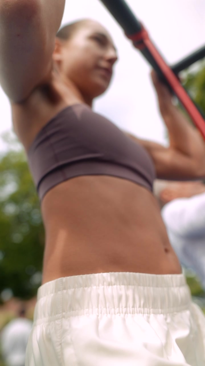 Primo piano di donna che esegue trazioni con elastico di resistenza