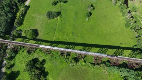 An-aerial-view-of-the-Moodna-Viaduct,-a-steel-railroad-trestle-in-Cornwall,-NY-with-a-train-on-it