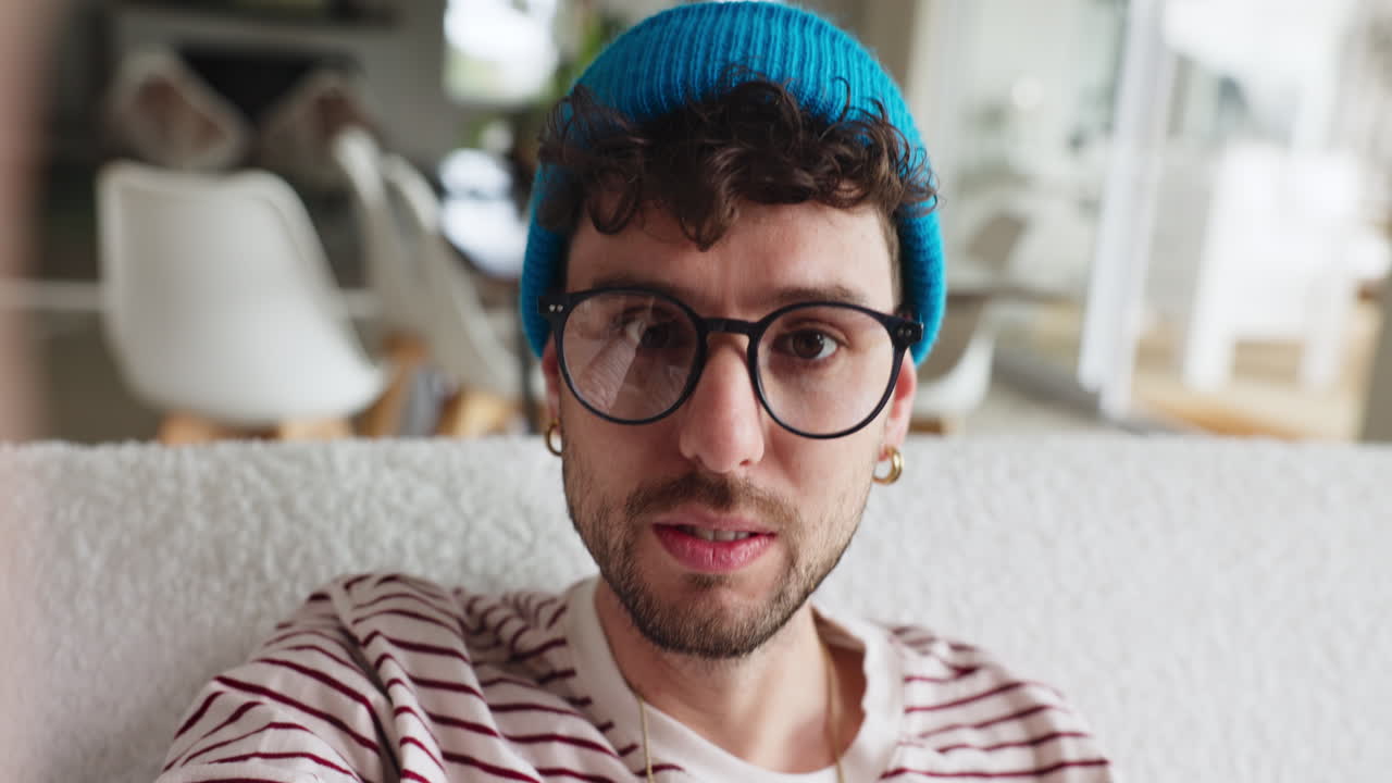 Portrait of a man with glasses and a beanie