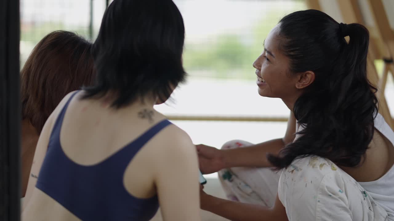 Two women in a relaxed indoor conversation