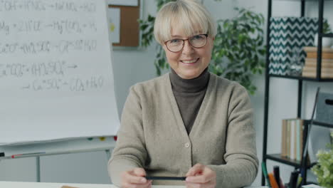 smiling teacher in online chemistry class