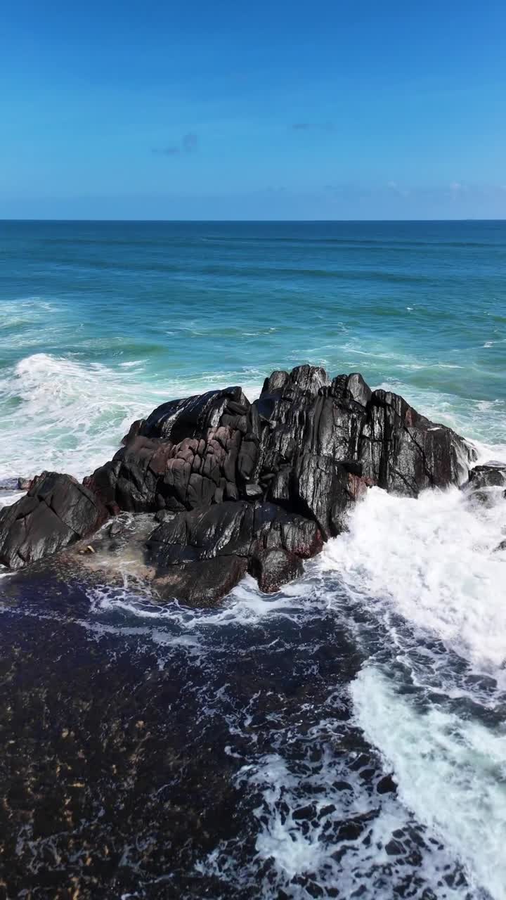 Scenic view of a rocky coastline where waves are crashing against the shore