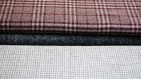 close up of plaid fabric texture samples in different color at tailor studio