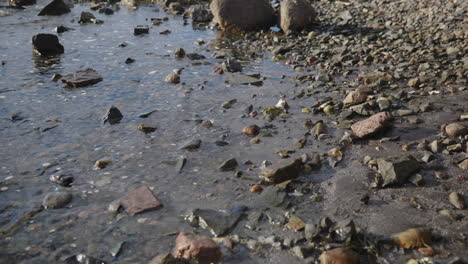 Small waves comes into the stone beach calmly