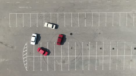 top view of the four cars circling in the parking lot. urban entertainment. club leisure.