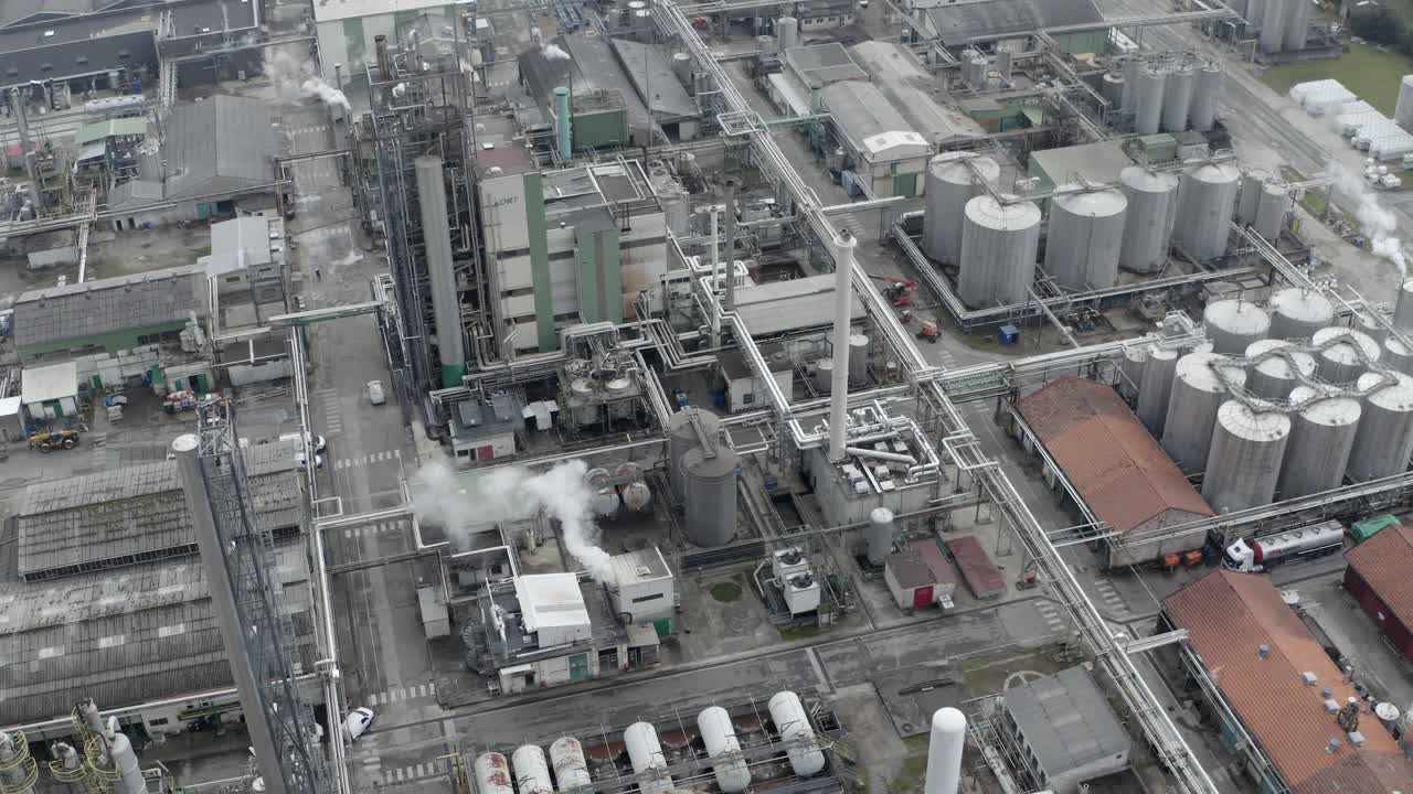 Large industrial complex, pipes, tanks, and steam, Vielle-Saint-Girons, France. Aerial top-down pov