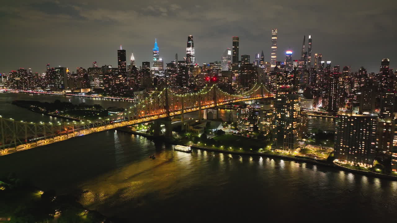 Illuminated Queensboro Bridge - New York City Skyline Glowing At Night - Drone Shot