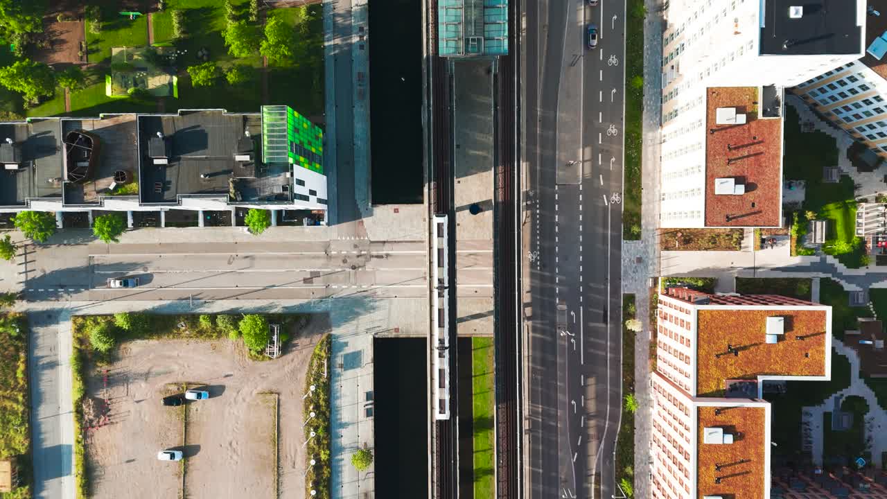 Aerial View of Modern City with Canal and Train