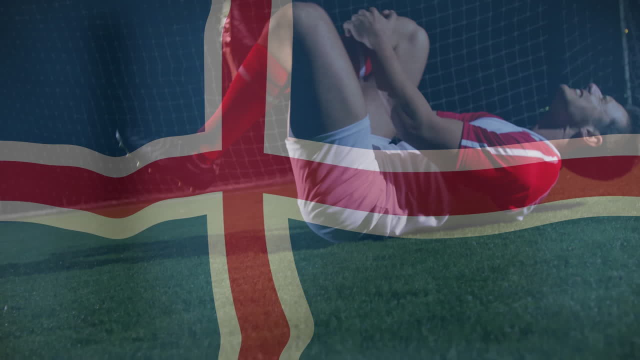 male soccer player clutching knee on turf, with British flag overlay highlighting health analytics