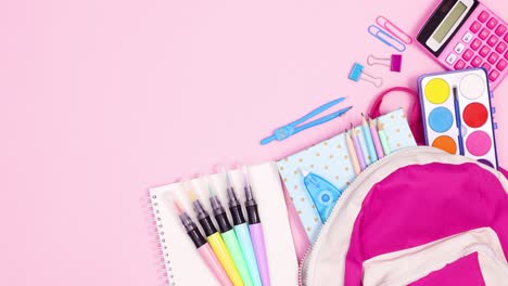 moving school stationery with backpack on pink theme. stop motion