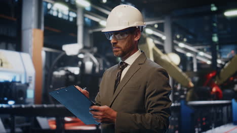 serious supervisor checking manufacturing process at production alone close up.