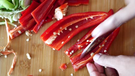 cutting a red pepper on a chopping board