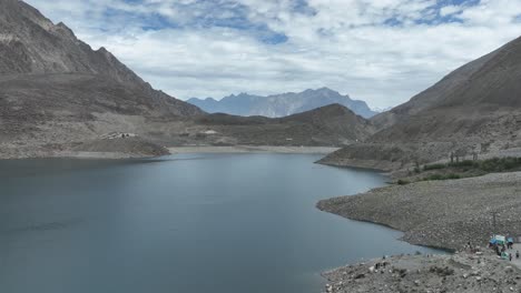 drone reveal shot of sadpara lake in skardu, pakistan, northern area , cinematic views and beautiful sky