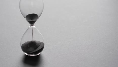 video of hourglass with sand pouring, copy space on white background