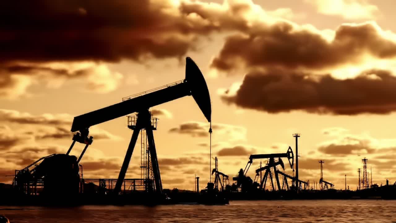 A Serene Sunset Over Pumpjacks: A Glimpse into the Oil Industry's Daily Dance Against the Backdrop of Nature's Golden Sky