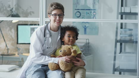 doctor and child with teddy bear